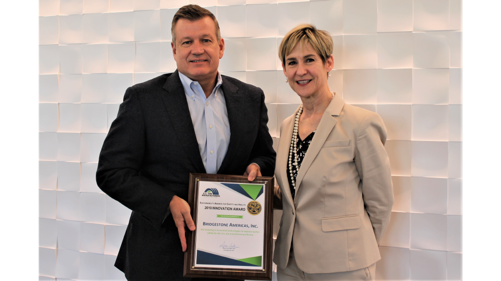 Bridgestone Americas CEO Gordon Knapp receiving award
